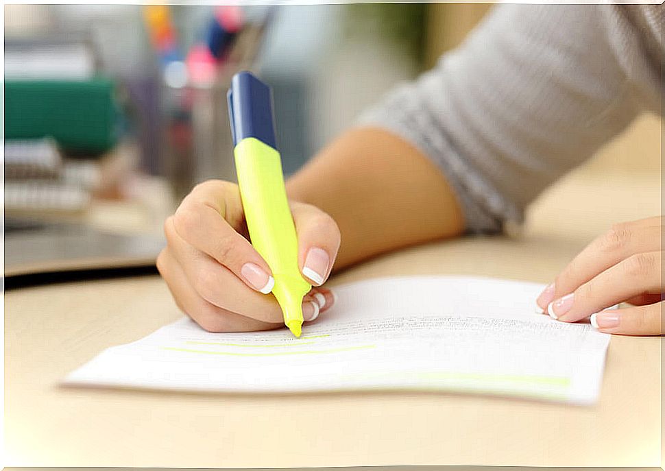 High school student underlining the notes and applying one of the study techniques.