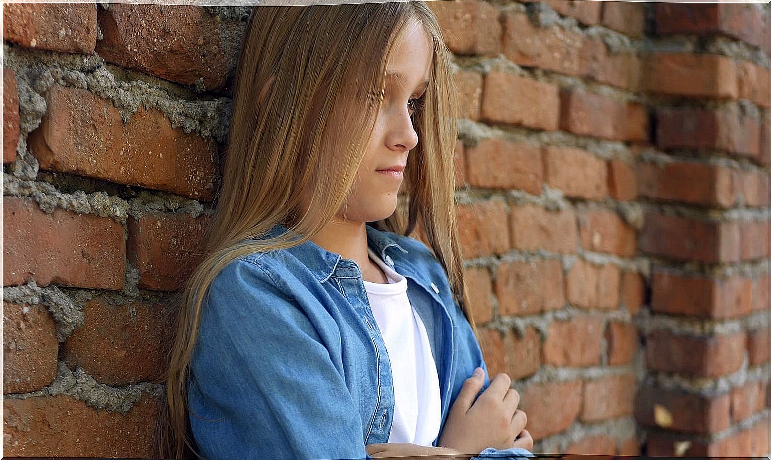 Girl thinking about how to help children who feel rejected.