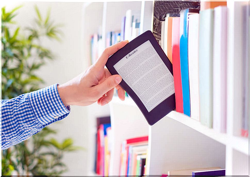 Man pulling an ereader from a shelf as if it were a book.