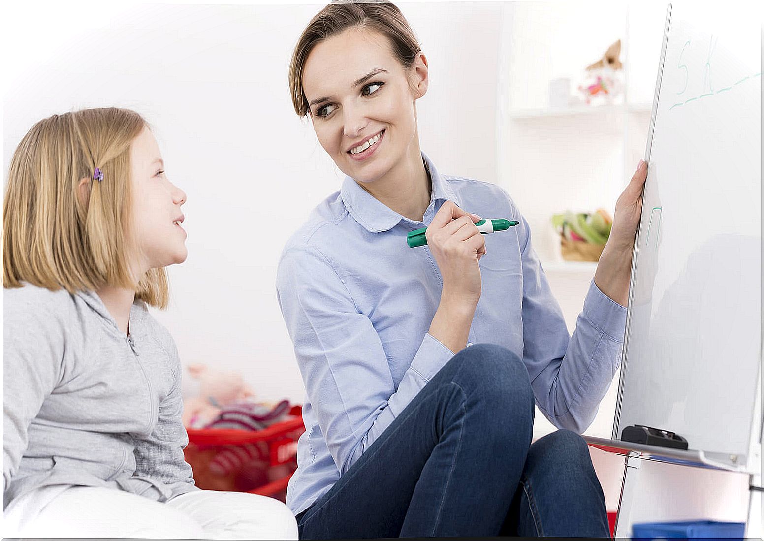 Girl with childhood dyslexia working with the speech therapist.