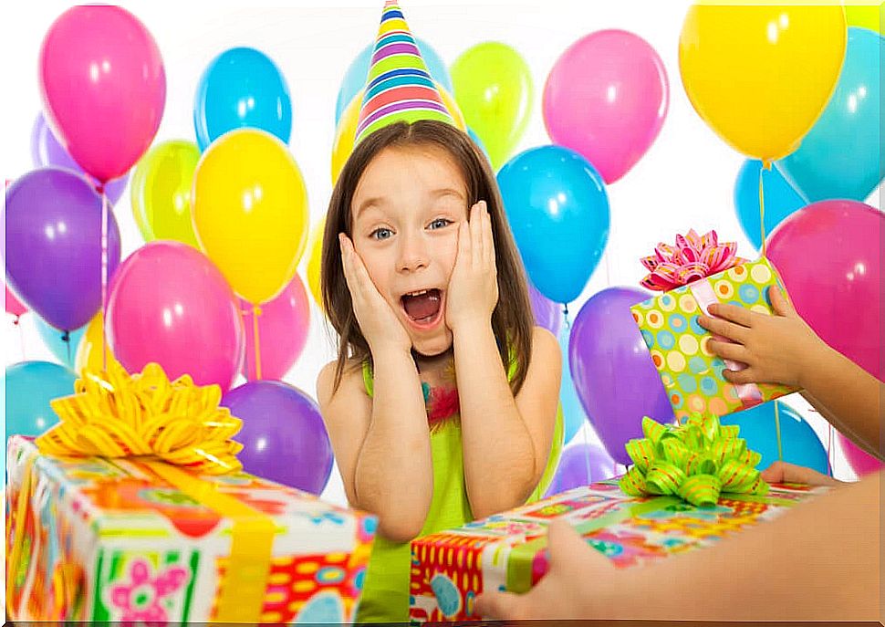 Little girl receiving many birthday gifts celebrated at home by confinement.