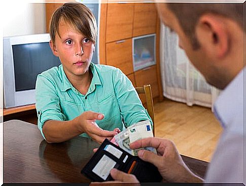 Child receiving weekly pay as part of financial education activities.