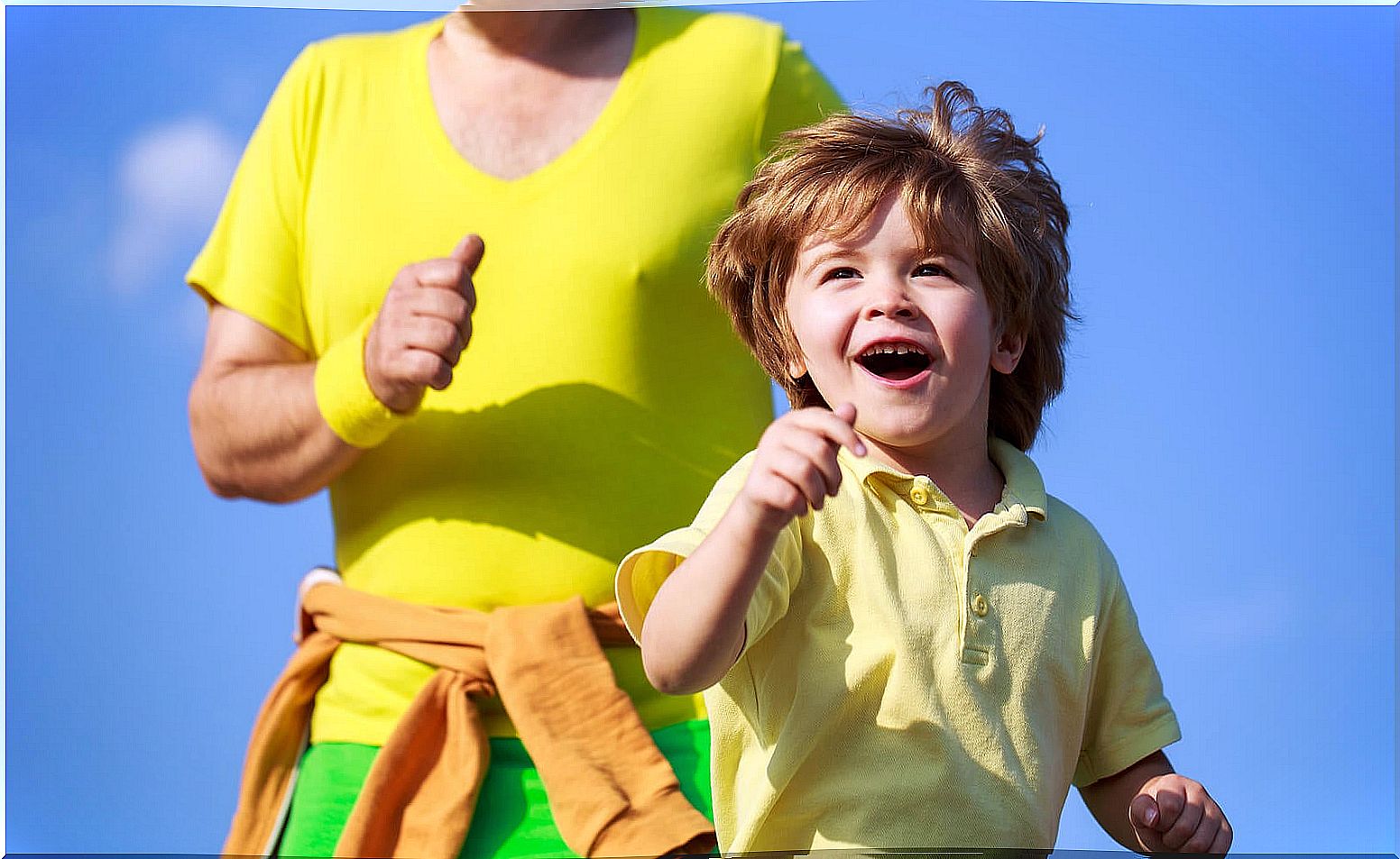 Boy running with his father.