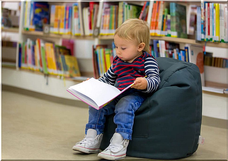 Boy reading a book in a baby store.