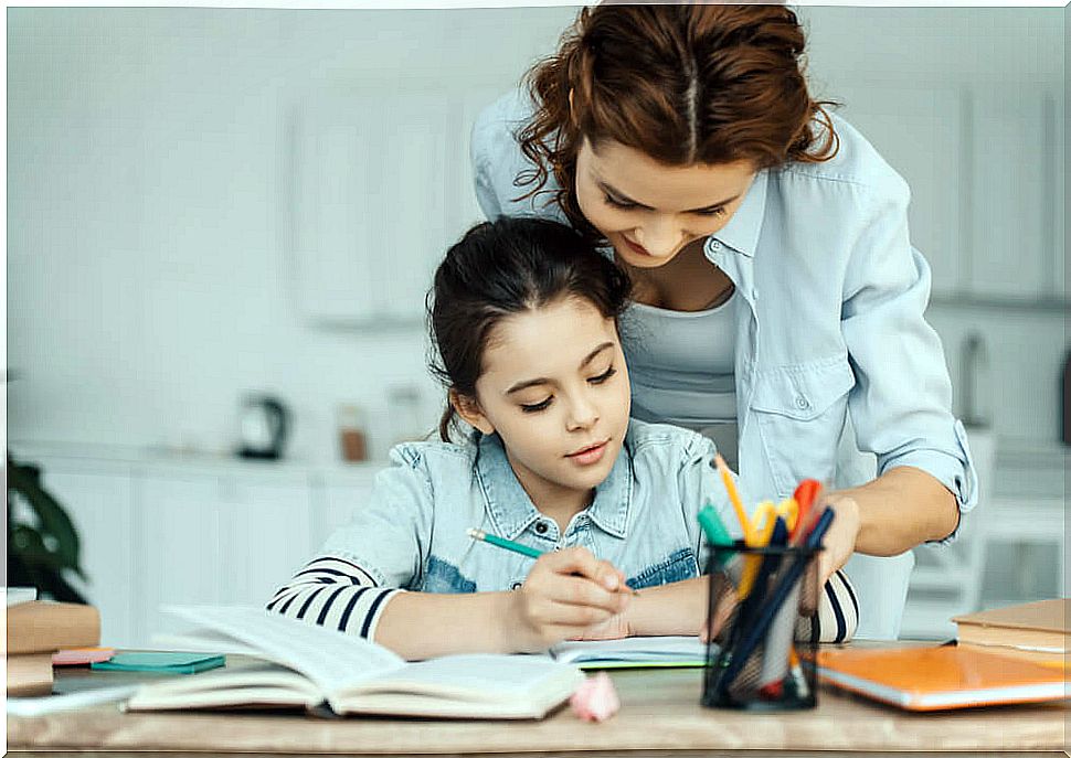 Little girl doing hiatus and diphthongs exercises with the help of her mother.