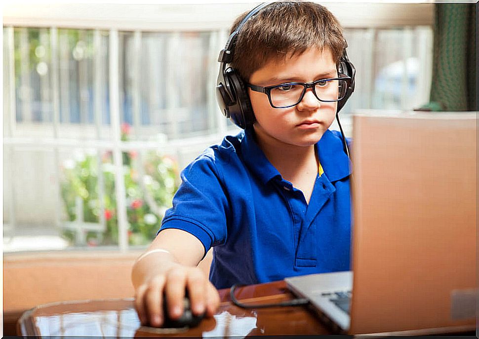 Child playing with the computer with the consent of their parents after learning about how children should use technology.