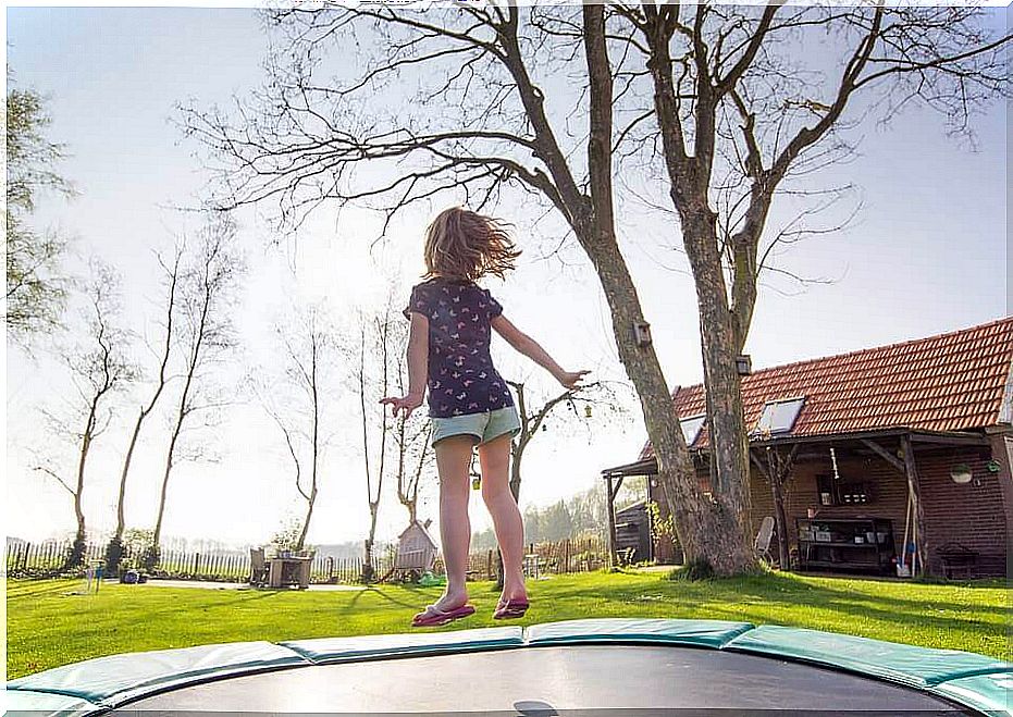 Girl jumping on a trampoline with a lot of energy because she is a moved girl.