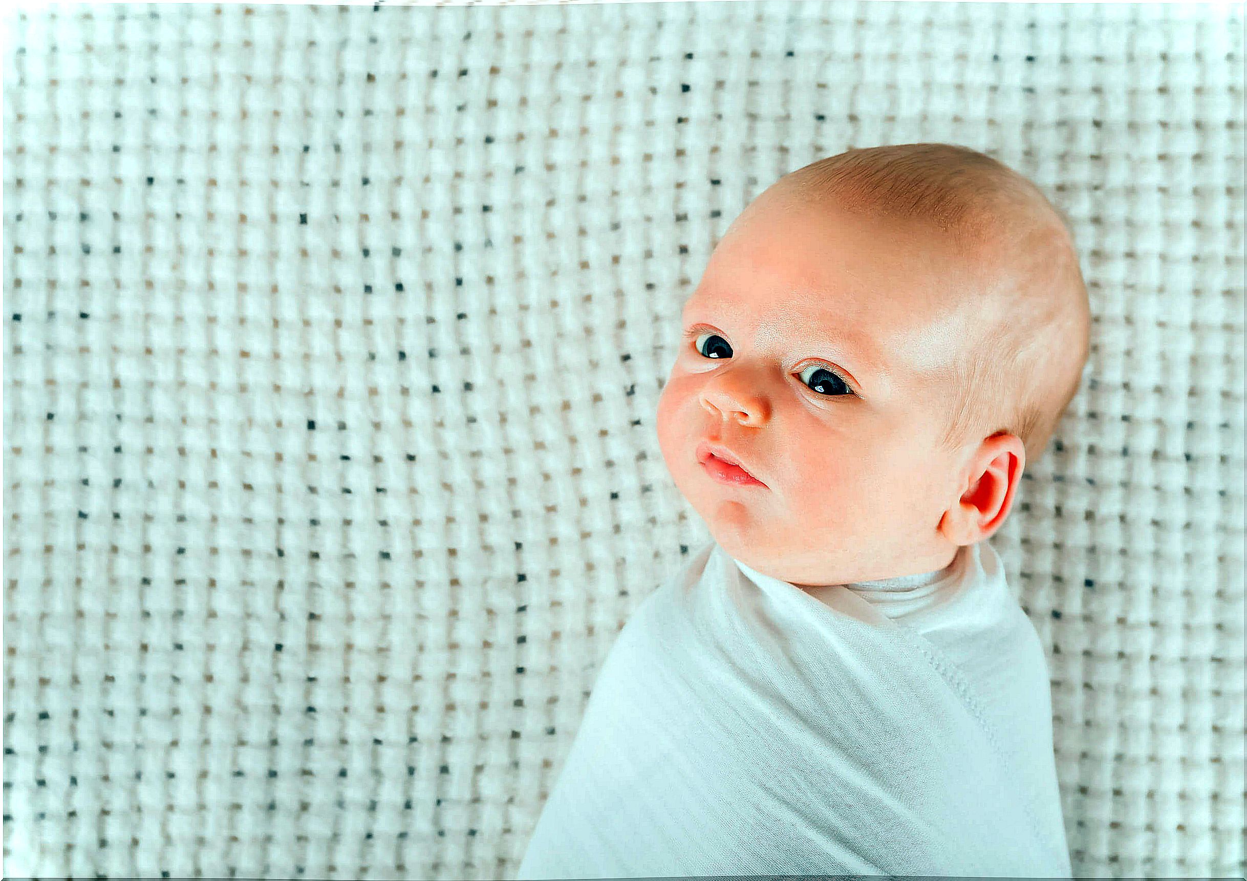 Newborn baby with pimples on his face.