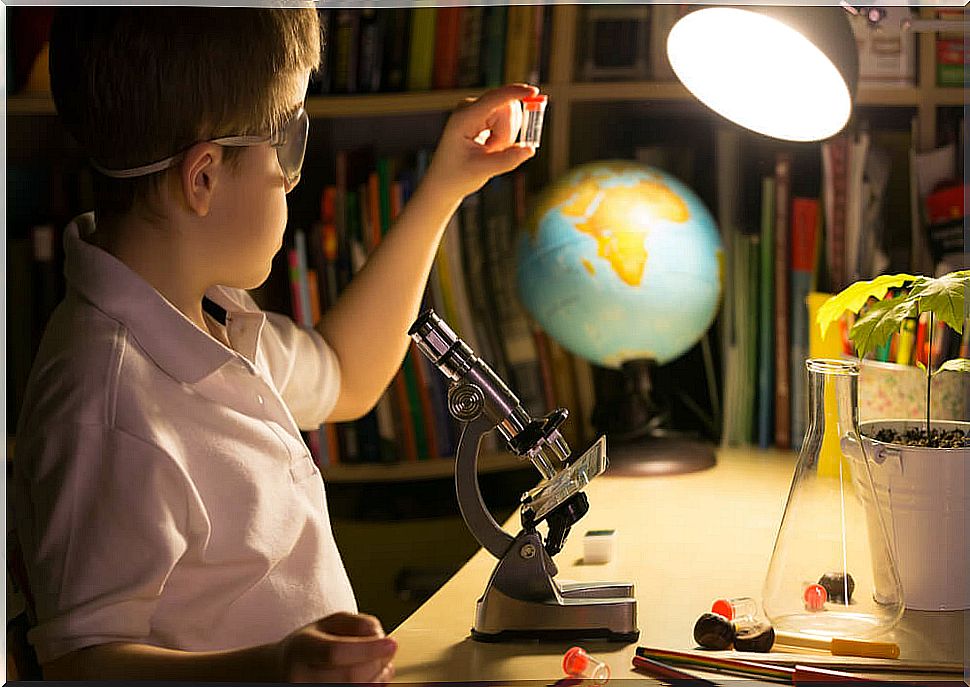 Very curious child learning at home with the telescope after reading some of the Project books.