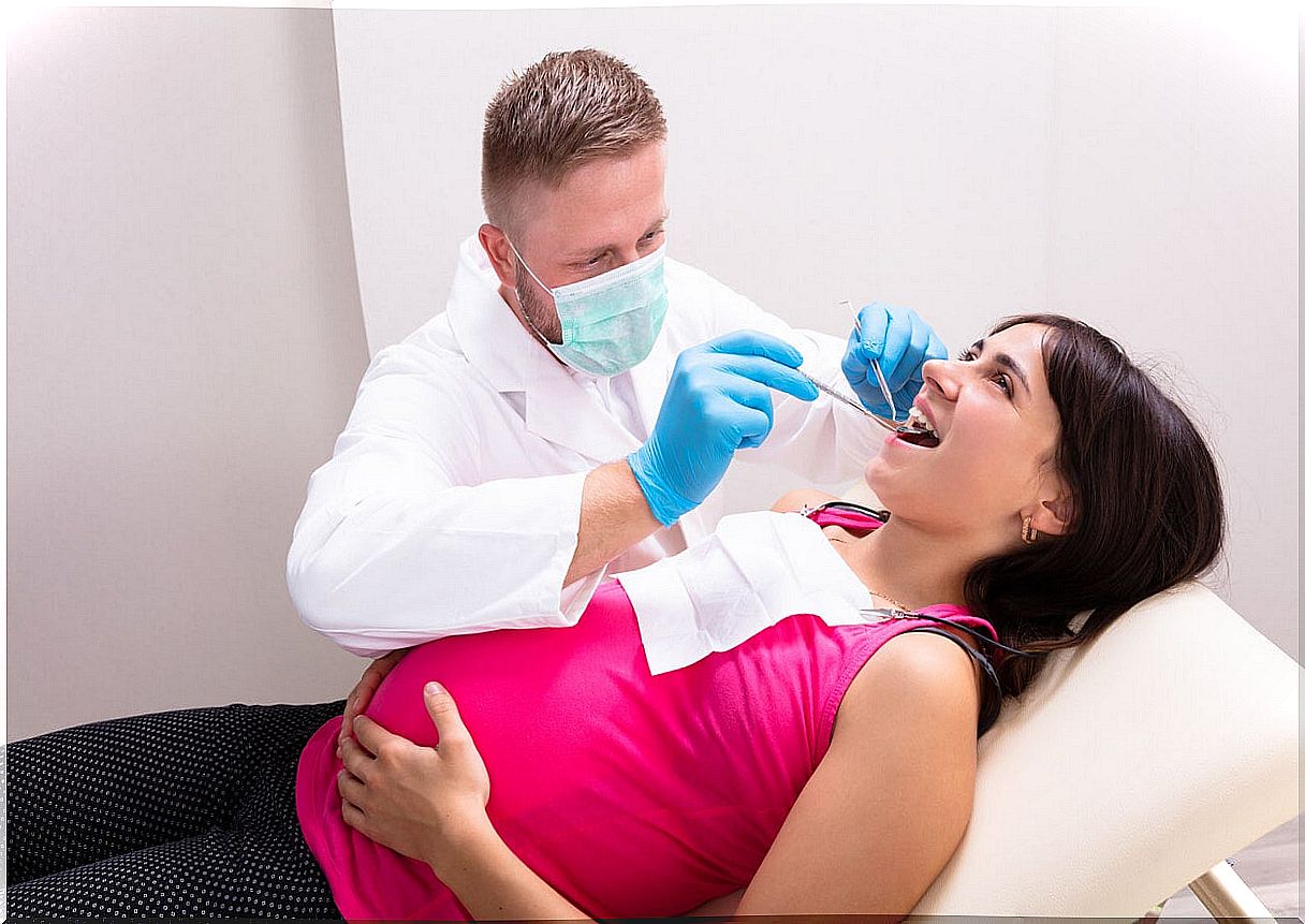 Woman at the dentist to take care of her teeth during pregnancy.