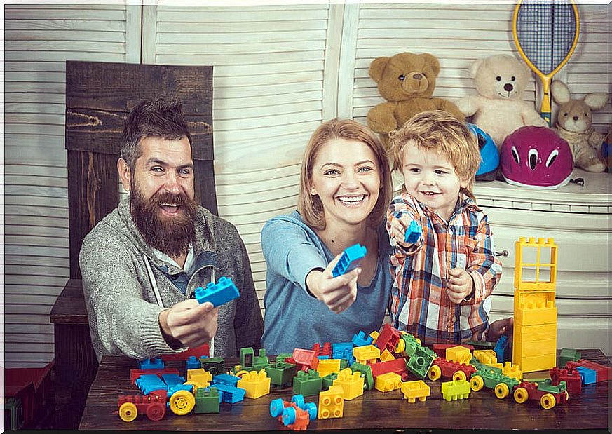 Family spending quality time with their young son playing with the building blocks.