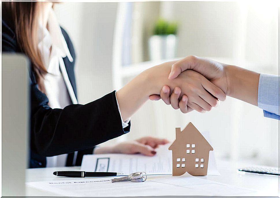 Couple signing the mortgage on their new house.